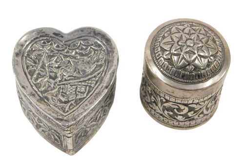 A 20thC jar and cover, the domed lid and body profusely repousse decorated with scrolls and...