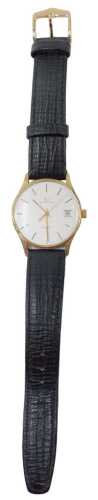 A Garrard 9ct gold cased gentlemen's wristwatch, with a silvered baton dial and date aperture,...