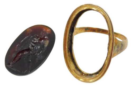 An antique intaglio dress ring, the carved orange stone intaglio depicting a gentleman with flowing robe and bowl, in a yellow metal framed border ring, unmarked, ring size K, 6.1g all in. (AF)