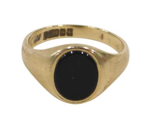 A 9ct gold signet ring, the oval black polished stone ring head, in a rub over setting, ring...