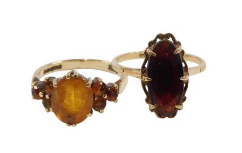 Two 9ct gold dress rings, comprising an oval smokey quartz set ring, ring size O&frac12;, and a citrine...