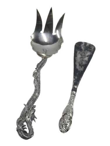 A 20thC serving fork, with entwined dragon handle, marked WS, 22cm long, and a silver handled...