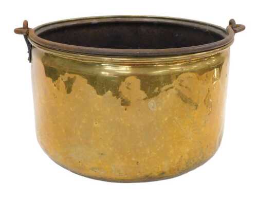 An early 20thC brass cauldron, with swing iron handle, of circular form with plain body, 41cm...