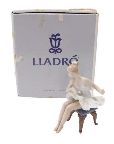 A Lladro figure group ballet dancer on stool, 18cm high, boxed.