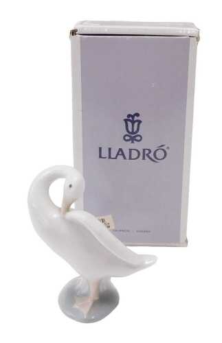 A Lladro figure group goose, 13cm high, boxed.