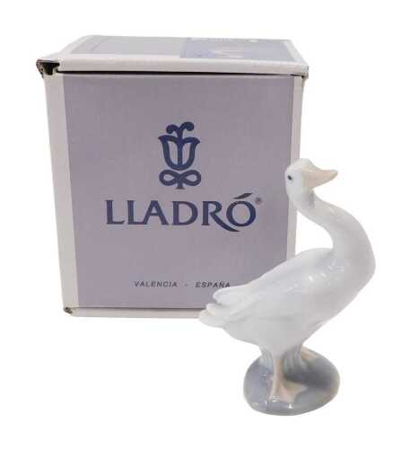 A Lladro figure group goose, 13cm high, boxed.