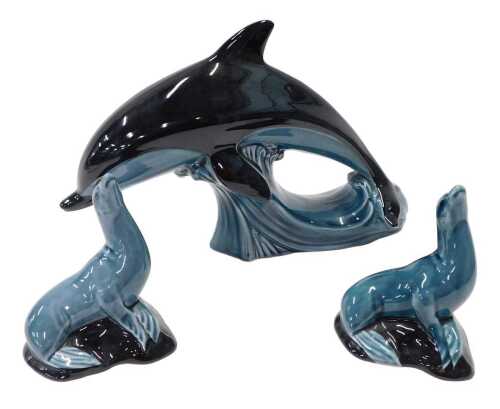 Various 20thC Poole pottery animals, dolphin, 20cm high, and two sealions. (3)