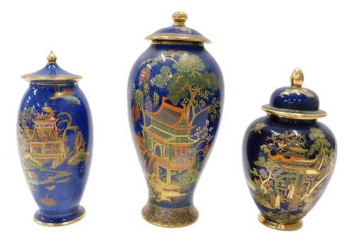 A Carltonware Bleu Royale chinoiserie vase and cover, 27cm high, and two other similar vases.