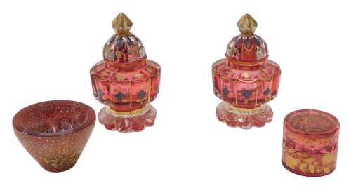 A pair of Bohemian ruby and clear glass lidded jars, each of small proportion with shaped bodies,...