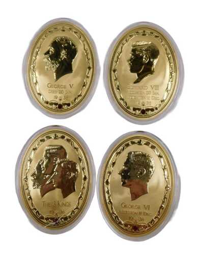 A Year of The Three Kings four piece gold plated medallion set, comprising portraits of George V,...