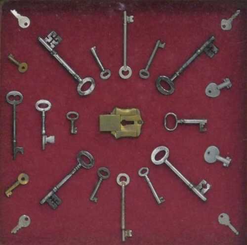 A cased framed set of keys, with central lock, the frame 47cm x 47cm.