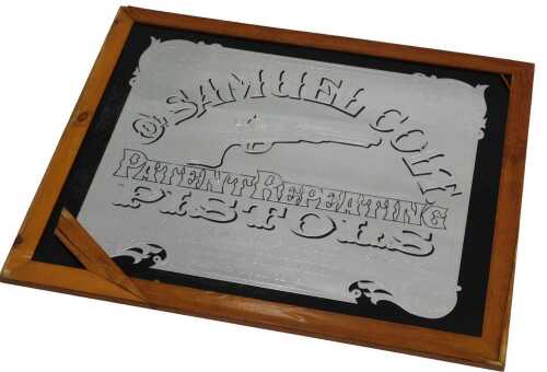 A Samuel Colt Patent Pistols reproduction mirror, in pine surround, 70cm x 81cm.
