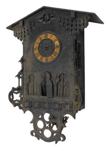 A heavily carved late 19thC Black Forest style wall clock, the 17cm diameter Roman numeric dial,...