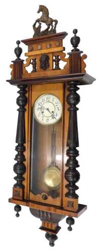 An early 20thC Vienna wall clock, the 7cm diameter Arabic dial, in a three part glazed walnut...
