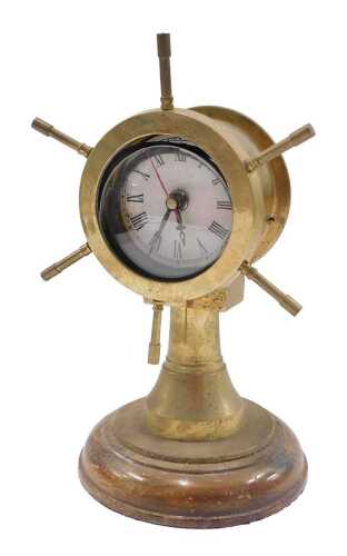 A 20thC brass ship's wheel mantel clock, on an oak base, with 7cm diameter Roman numeric dial...