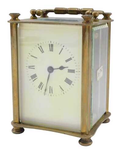 A 20thC brass carriage clock, with 6cm wide backplate set with Roman numeric dial, revealing a...