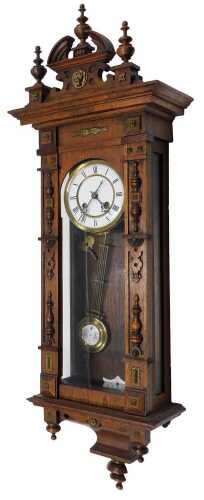 An early 20thC oak cased Vienna wall clock, the 13cm diameter Roman numeric dial revealing a...