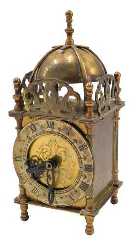A 20thC lantern clock, with domed top, 9cm diameter Roman numeric chapter ring and battery...