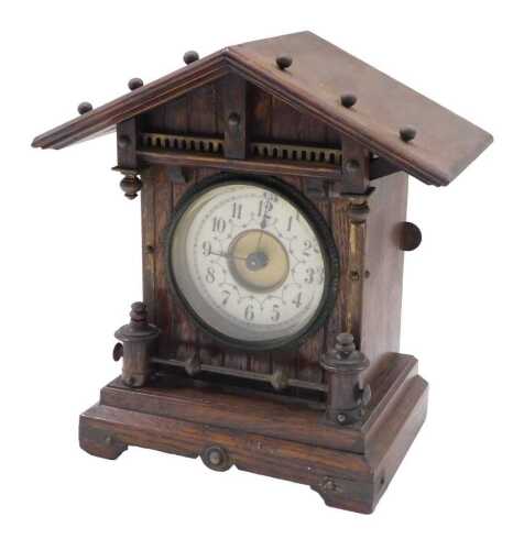 A late 19thC Continental oak cased mantel clock, with fancy 8cm diameter dial, in an...