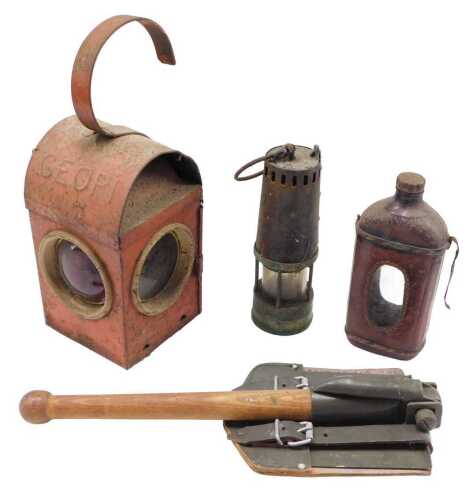 A vintage railway lantern, in red metal arched case, with three part glass sections, and fixed...