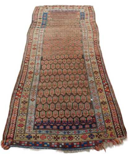 A 20thC Turkoman runner, of rectangular form, with an inner geometric repeat pattern, the outer...