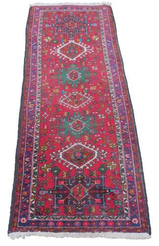 A 20thC runner, possibly Iran, of rectangular form, the outer border with a repeat geometric...