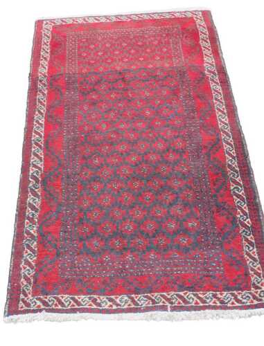 A 20thC hand knotted runner, possibly Afghanistan, of rectangular form, set with a geometric...