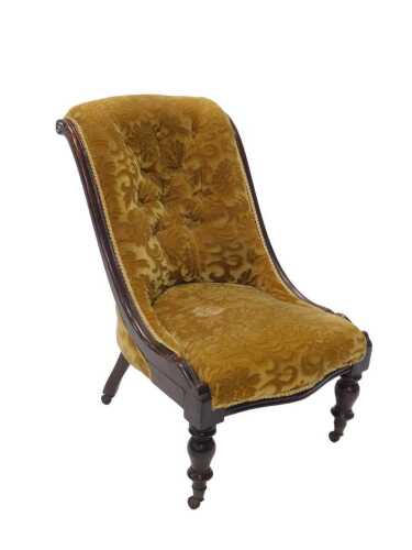 A 19thC walnut stained nursing chair, with scroll bead back, on turned front legs terminating in...