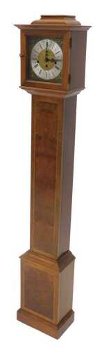 A 20thC walnut cased chiming granddaughter clock, with 16cm wide dial with Roman numeric and...