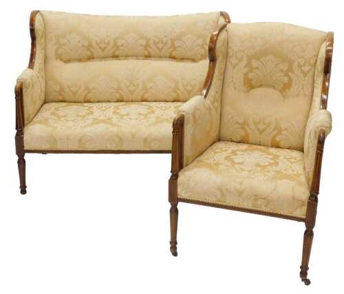 An Edwardian mahogany salon suite, comprising three seater settee, with scroll arms and shaped...