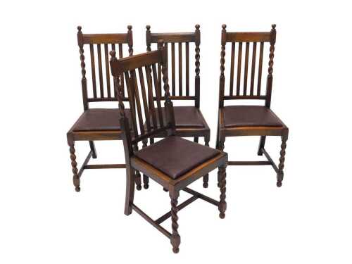 A set of four early 20thC oak barley twist dining chairs, each with vertical splats, drop in...