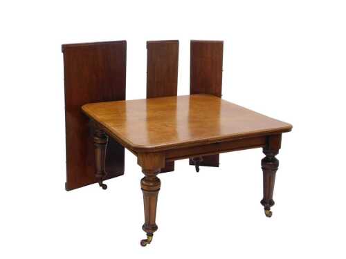 A 19thC mahogany extending dining table, the oblong top raised on heavy turned reeded legs...
