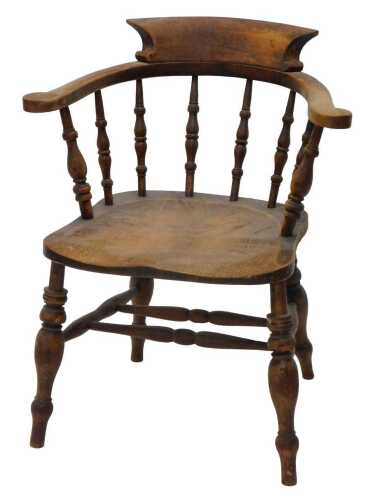 A 19thC elm smoker's bow chair, with shaped back and seat, on turned front legs joined by...