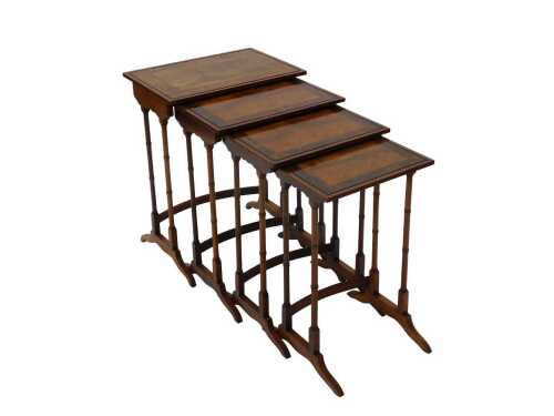 A nest of four walnut and mahogany herringbone inlay tables, each of rectangular form, with a...