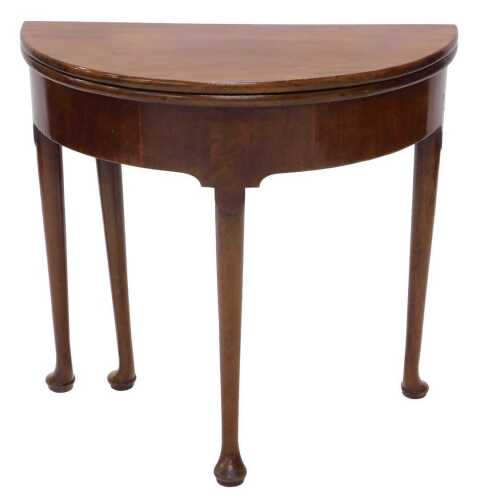 A 19thC mahogany D end fold over tea table, on turned legs terminating in pad feet, when closed...