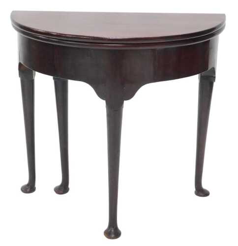 A 19thC mahogany D end fold over tea table, on turned legs terminating in pad feet, when closed...