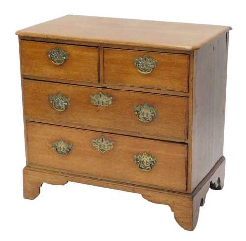 An early 19thC oak chest of two short and two long drawers, with brass plate back swan neck...