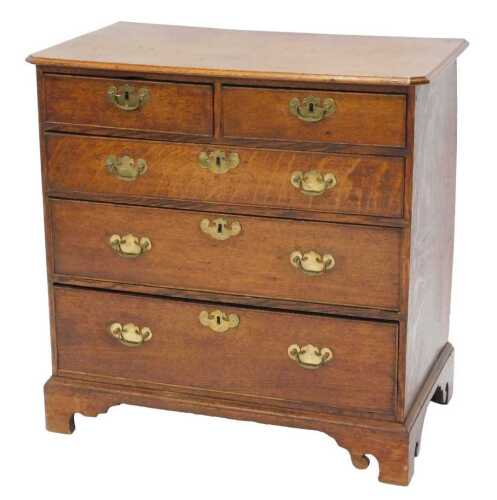 An 18thC oak chest of two short and three long drawers, each with later plate back swan neck...