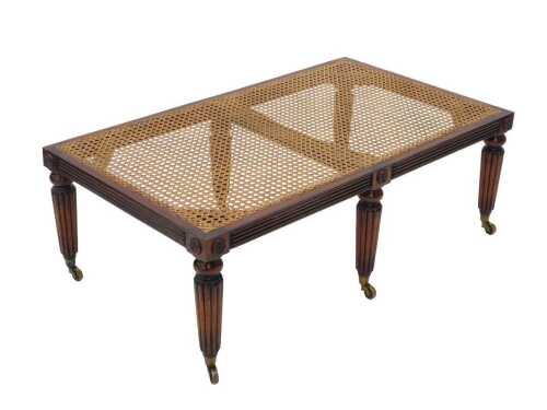 A mahogany framed bergere topped duet stool, of rectangular form, with reeded legs surmounted by...