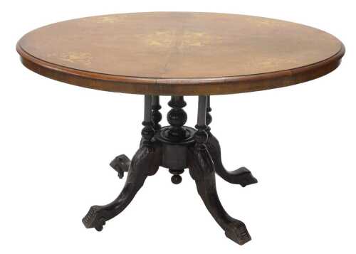A Victorian walnut and inlaid loo table, the oval top with a quarter veneer decorated with urns...