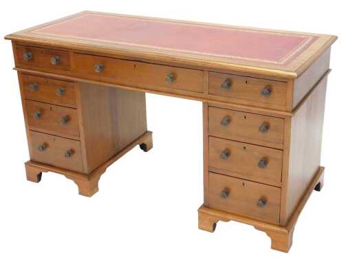 A late Victorian mahogany twin pedestal writing desk, the one piece tooled leather top raised...