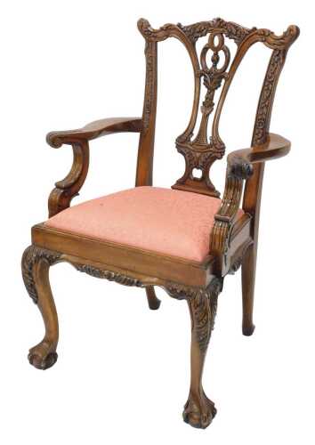 A heavily carved late 20thC Chippendale design carver chair, with carved ear cresting rail above...