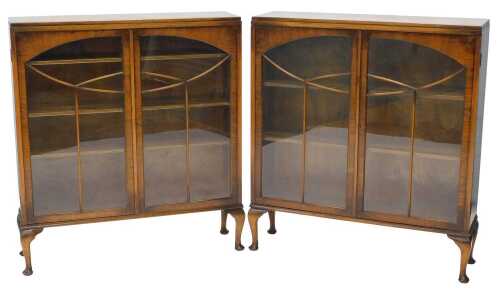 A pair of mid-20thC Art Deco walnut display cabinets, each with astragal glazed doors, on...