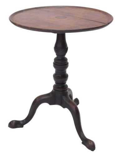An early 19thC mahogany tripod table, the circular top with a central roundel, raised on...