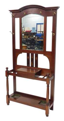 A late 19thC mahogany Art Nouveau hall stand, with six pegs centred by a bevelled mirror raised...