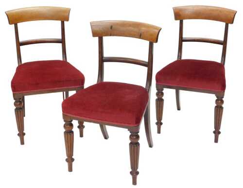 A set of three Victorian mahogany dining chairs, with curved horizontal cresting rails, and...