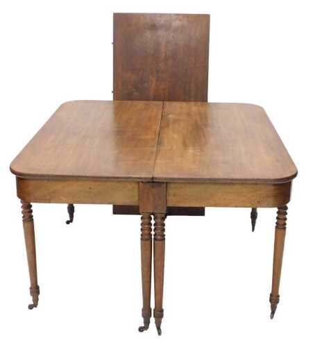 A George III mahogany extending dining table, the D end raised on turned legs with one leaf,...