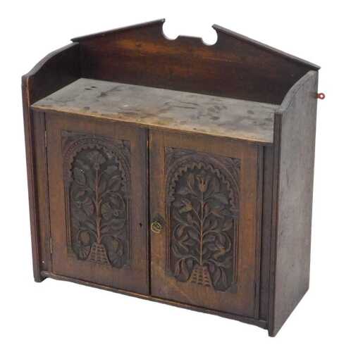 A principally 18thC oak hanging cupboard, of small proportion, with a three part galleried back...