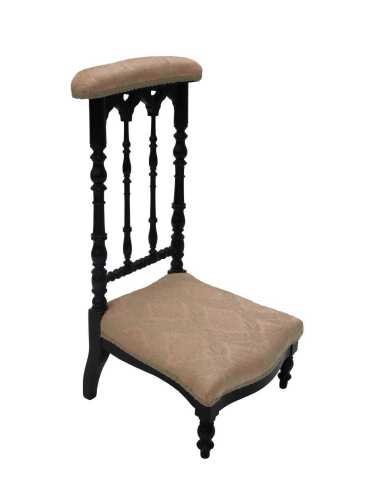 A late 19thC ebonised prie dieu chair, with overstuffed top and seat, in later peach floral...