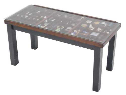An early 20thC coffee table, of rectangular form, with Perspex lid containing a number of...